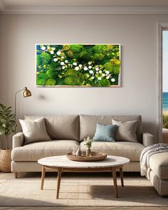 a living room filled with furniture and a painting on the wall above it's coffee table