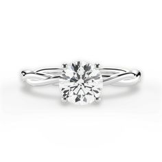 a white gold engagement ring with a twisted band and a round cut diamond in the center