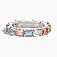 Pastel Emerald-Cut Multi Colored Gemstone Ring - Platinum. Evoking all the colors of springtime, this pastel piece features emerald-cut lemon quartz, topaz, aquamarine, morganite, prasiolite, lab champagne sapphire, and amethyst for a fresh, colorful look. 
 
 Our eternity bands are crafted meticulously to perfectly fit your finger. Each unique ring size features a slightly varied number of gemstones to ensure a fit that is as comfortable as it is glamorous. Elegant Emerald Cut Platinum Gemstone, Multicolor Emerald Cut Multi-stone Rings, Multicolor Multi-stone Emerald Cut Rings, Multi-stone Platinum Jewelry With Emerald Cut, Elegant Multi-stone Emerald Platinum Ring, Emerald Cut Multi-stone Platinum Rings, Modern Multicolored Multi-stone Gemstones, Luxury Emerald-cut Diamond Amethyst Ring, Champagne Sapphire