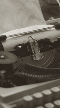 an old fashioned typewriter with paper on it