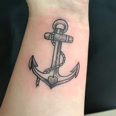 an anchor tattoo with a heart on the wrist