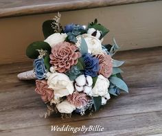 a bridal bouquet sitting on top of a wooden floor next to a stair case