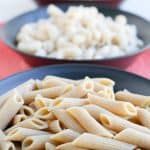 two plates filled with pasta and white rice