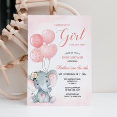 a pink elephant baby shower party with balloons