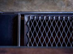 a close up view of a metal grill on a table with no one around it