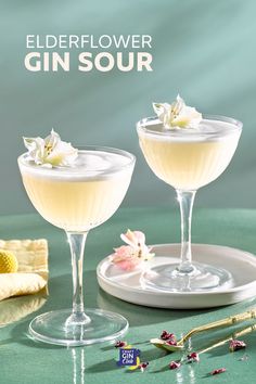 two glasses filled with white liquid and flowers