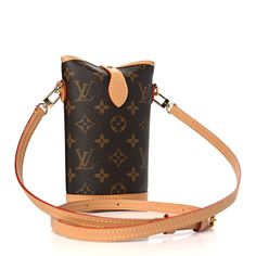 This authentic LOUIS VUITTON Monogram Fold Me Pouch. This elegant handbag is finely crafted of monogram coated canvas with vachetta cowhide leather trim. The handbag features a removable shoulder strap, and gold hardware. The folding top is secured with a vachetta leather crossover strap and opens to a compact brown canvas interior. Elegant Handbag, Brown Canvas, Leather Trim, Authentic Louis Vuitton, Cowhide Leather, Leather Trims, Crossover, Louis Vuitton Monogram, Gold Hardware