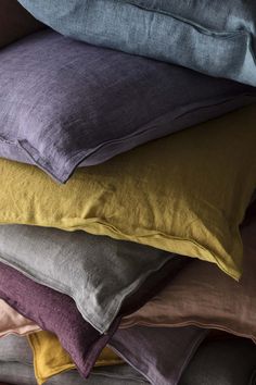 pillows stacked on top of each other in different colors