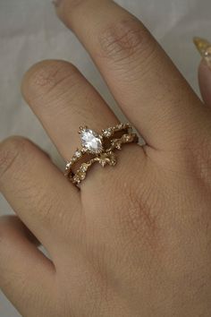 a woman's hand with a ring on it and a diamond in the middle