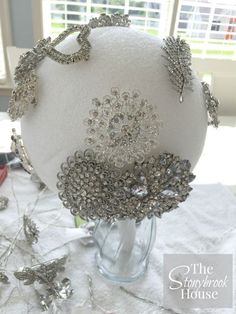 a white hat with lots of silver beads on it sitting on a table in front of a window