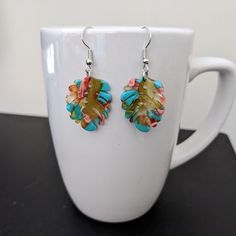 These lightweight earrings are made with colorful resin leaf pendants and nickel free ear wires. Dangle length is approximately 1 inch, not including ear wires. To extend the life of your earrings, avoid contact with sweat, lotions, and other chemicals. Please message me with any questions. To see other earring options, check out my full store: https://www.etsy.com/shop/shopcraftyoctopus/ Multicolor Nickel-free Dangle Flower Earrings, Nickel Free Multicolor Dangle Flower Earrings, Nickel-free Multicolor Dangle Flower Earrings, Multicolor Leaf Shaped Jewelry For Gifts, Multicolor Leaf-shaped Jewelry Gift, Multicolor Glass Earrings With Colorful Beads, Multicolor Glass Beaded Earrings, Multicolor Czech Glass Drop Earrings, Multicolor Glass Drop Earrings