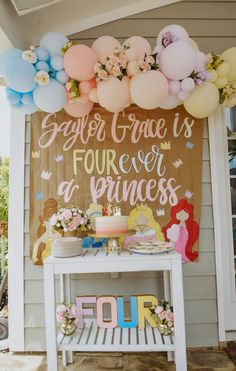 a princess themed birthday party with balloons, cake and flowers on the front porch area