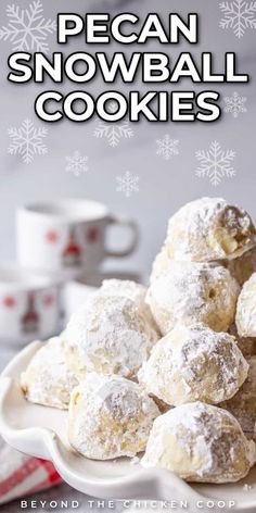 a white plate topped with powdered sugar covered snowball cookies