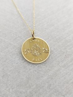 "Amor Fati Necklace - Engraved Love of Fate Charm - Gold Graduation Charm - Gold Stoic Pendant ▪️ A beautiful and clean engraved Amor Fati pendant made out of 14K Solid Real Gold. Available only in yellow gold! Pendant Thickness: 0.50mm Jump Ring inner diameter: 4mm Dimensions: - 13mm / 0.52 inches - 15mm / 0.59 inches - 18mm / 0.70 inches - 20mm / 0.78 inches - 22mm / 0.86 inches - 24mm / 0.94 inches Necklace Length - You can choose your chain length from 35CM to 50CM. The pendant is available Spiritual 14k Gold Jewelry Stamped 14k, 14k Gold Necklace For Valentine's Day, Symbolic Engraved Jewelry For Valentine's Day, Valentine's Day Symbolic Engraved Jewelry, Spiritual 14k Gold Jewelry For Anniversary, Engraved 14k Gold-filled Yellow Gold Jewelry, Symbolic Rose Gold Necklace For Anniversary, Recycled Gold Medallion Jewelry For Anniversary, Engraved 14k Gold Jewelry For Valentine's Day