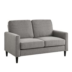 a gray couch sitting on top of a white floor