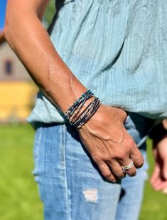 A mix of dark blue and light blue shades coupled with navy blue and silver Czech glass seed beads on strong elastic cording. The blues mix is a 5-wrap, paired with a navy blue 3- or 5-wrap, both featuring specks of silver glass Czech beads and silver-plated beads. Wear them together, or separately depending on the day's vibe. Blue represents the sky and the sea and is associated with open spaces, freedom, intuition, imagination, inspiration, and sensitivity, along with depth, trust, loyalty, sin Adjustable Multi-strand Wrap Bracelet With Tiny Beads, Adjustable Multi-strand Tiny Beads Wrap Bracelet, Blue Bohemian Wrap Bracelet With Colorful Beads, Bohemian Blue Wrap Bracelet With Colorful Beads, Blue Wrap Bracelet With Colorful Beads, Adjustable Blue Wrap Bracelet With Faceted Beads, Blue Wrap Bracelet With Colorful Beads For Festivals, Festival Blue Wrap Bracelet With Colorful Beads, Festival Wrap Bracelet With Colorful Beads