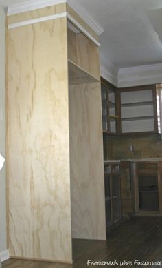 an unfinished kitchen with wood floors and cabinets