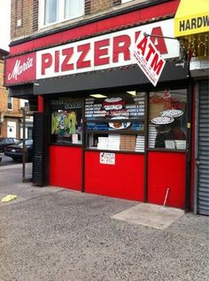 there is a pizza shop on the street corner