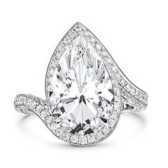 a pear shaped diamond ring with diamonds on the band and an oval center stone in the middle