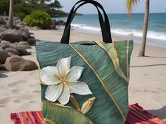 Elevate your everyday essentials with our stunning Banana Leaf and Gardenia Tote Bag! Radiating tropical charm, this tote features a vibrant, custom-printed design that masterfully blends the lush greenery of banana leaves with the delicate beauty of gardenias. Available in 3 sizes to add both functionality and style, these custom-printed tote bags come with multiple handle colors to match your designs. Crafted from high-quality, durable polyester, this tote is perfect for everything from beach Green Tropical Beach Bag For Everyday Use, Tropical Style Shopping Bags For Summer, Tropical Green Beach Bag For Everyday Use, Tropical Rectangular Bag For Beach Season, Tropical Green Shoulder Bag For Travel, Tropical Rectangular Shoulder Bag For Beach Season, Green Tropical Shoulder Bag For Summer, Summer Tropical Green Shoulder Bag, Tropical Style Tote Bag For Daily Use