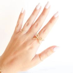 Bows? We love her! This adorable ring features a delicate 2mm beaded band adorned with a charming gold beaded bow adding a touch of sophistication to any outfit, perfect for both everyday wear and special occasions. Elevate your accessory game with this timeless, chic piece. 🤍🎀✨ Made from 14 K gold filled beads and durable elastic string so perfect for everyday wear! Sweat proof, water proof and tarnish free! Handstrung with love in College Station, Texas. SKU: 0530-2404 Delicate Gold Rings For Party, Delicate Gold Party Rings, Adjustable Feminine Gold Ring, Dainty Gold Midi Rings For Party, Gold Dainty Midi Rings For Party, Beaded Bow, College Station Texas, Timeless Chic, Bow Ring