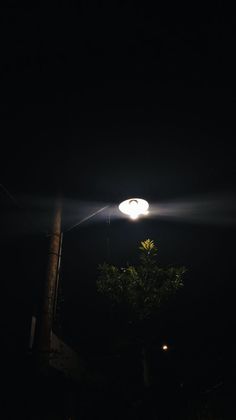 a street light is lit up in the dark