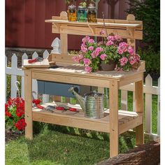 a potting bench with flowers and gardening tools