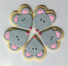 four decorated cookies in the shape of elephants