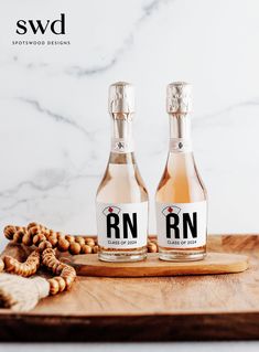 two bottles of r n are sitting on a cutting board next to nuts and pretzels