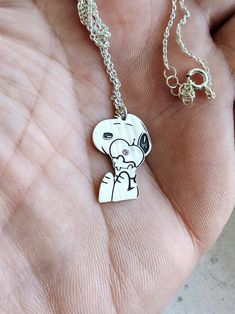 The necklace is a beautiful gift for any occasion to surprise your loved one. Made of high-quality materials and with an embedded spirit, it is a fun and gentle gift for anyone who likes Snoopy's little character. A text or an important date can be written on the back of the figurine. necklace length: 45 cm /  17.72 inches. pendant height: 22mm / 0.87inch. pendant width: 15mm / 0.59inch.  material: silver sample 925 Cute Nickel-free Pendant Jewelry, Cute Nickel-free Sterling Silver Necklaces, Cute Silver Pendant Charm Necklace, Cute Silver Charm Necklaces, Cute Sterling Silver Pendant Charm Necklaces, Cute Pendant Charm Necklace For Gift, Cute Sterling Silver Pendant Charm Necklace, Cute Charms Jewelry For Gifts, Cute White Charm Necklace For Gift