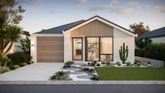 a house with a cactus in front of it and landscaping around the entrance to the home