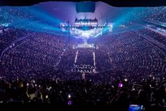 a large crowd is in an arena for a concert