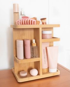 a wooden shelf filled with cosmetics and personal care items on top of a wood table