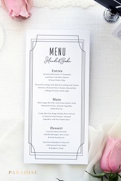 a menu card sitting on top of a table next to pink roses and wine glasses