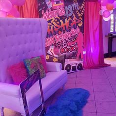 a room decorated in pink and purple with balloons