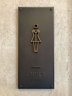 a sign on the wall that says ladies