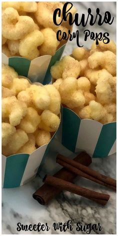 two paper cups filled with cinnamon sugar covered cornflakes on top of a marble counter