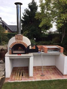 an outdoor brick pizza oven in the backyard