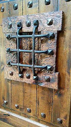 an old wooden door with iron bars and knobs on the front, side or back