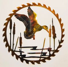 a metal clock with a bird flying over it