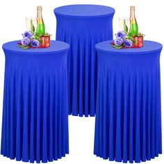 two round tables with blue tablecloths and champagne bottles