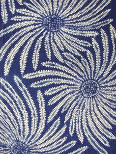 an intricate blue and white design on fabric