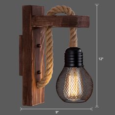 a light that is hanging from a wooden wall with rope around it and an old fashioned bulb