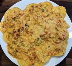 a white plate topped with nachos covered in cheese