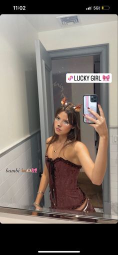 a woman taking a selfie in a bathroom mirror