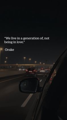 a car driving down a highway at night with a quote written on the side of it