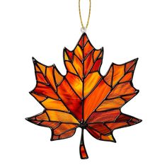 a stained glass maple leaf ornament hanging from a string