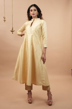 Item: 2 piece Anarkali Set for women. Dupatta is NOT included. From the Mughal-e-Azam era to the present age, Anarkali suits have enthralled us with their silhouette! Step out in style with this Ivory Anarkali and Ankle pant 2 piece set that comes in a stylish and contemporary silhouette! The color is definitely charming while the Banarasi brocade detailing around the neckline, sleeves and ankles makes it regal! This is a 2 piece set, should you need a dupatta, we have several and this set has b Cotton Silk Floor-length Anarkali Set, Elegant Beige Traditional Wear For Navratri, Festive Cream Slub Silk Traditional Wear, Elegant Beige Anarkali Set For Navratri, Elegant Gold Slub Silk Anarkali Set, Ankle-length Palazzo Set With Resham Embroidery For Eid, Ankle-length Palazzo Set With Zari Work For Diwali, Unstitched Ankle-length Kurta With Resham Embroidery, Ankle-length Resham Embroidered Palazzo Set