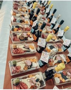 a table topped with lots of trays filled with different types of cheese and meat