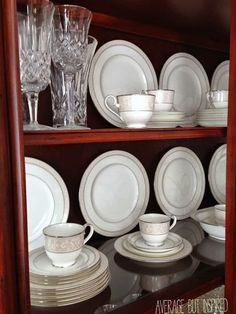 the china cabinet is filled with dishes and glasses